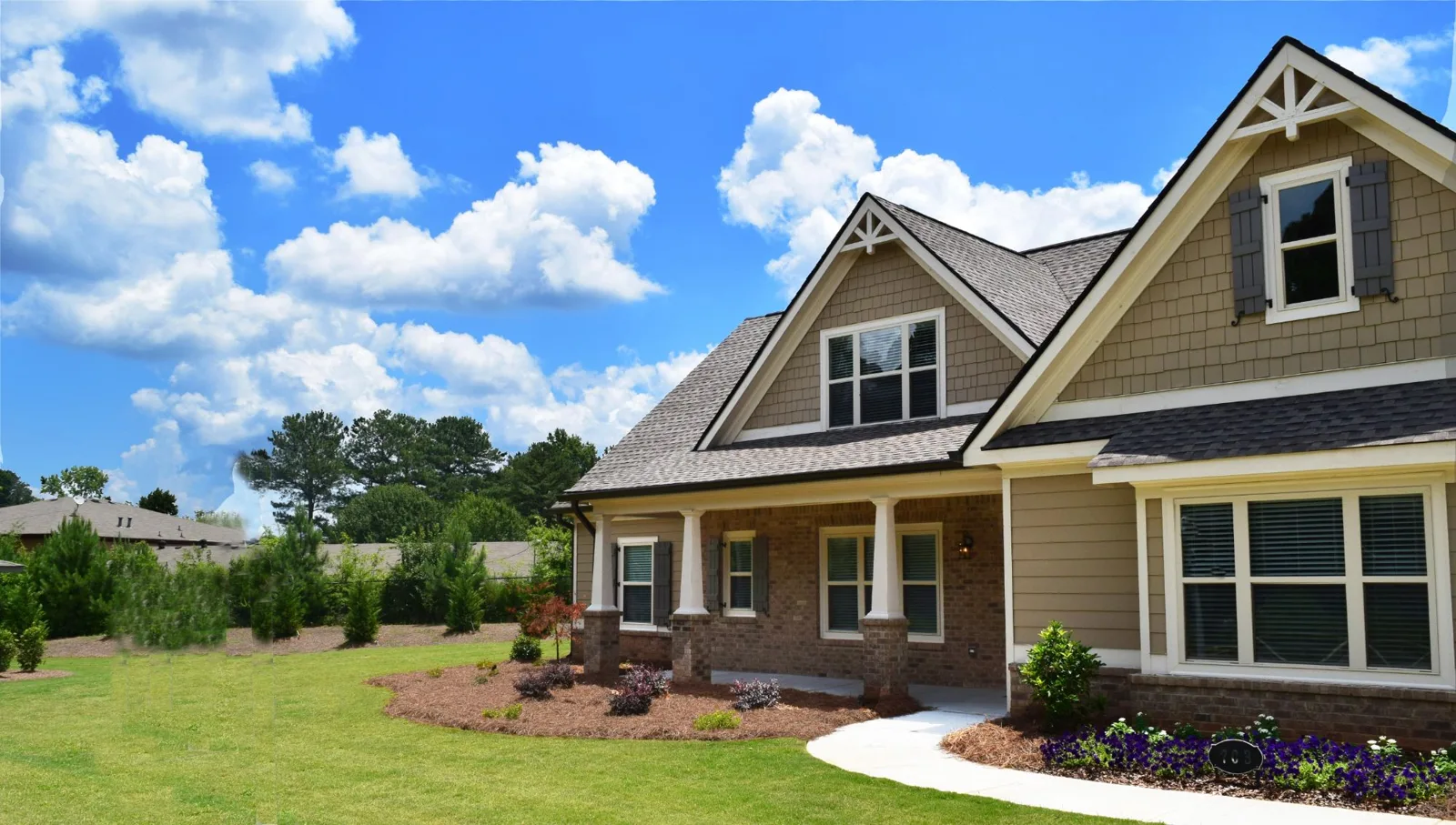 A gabled home with a front porch and landscaped lawn in Retreat at Mill Creek